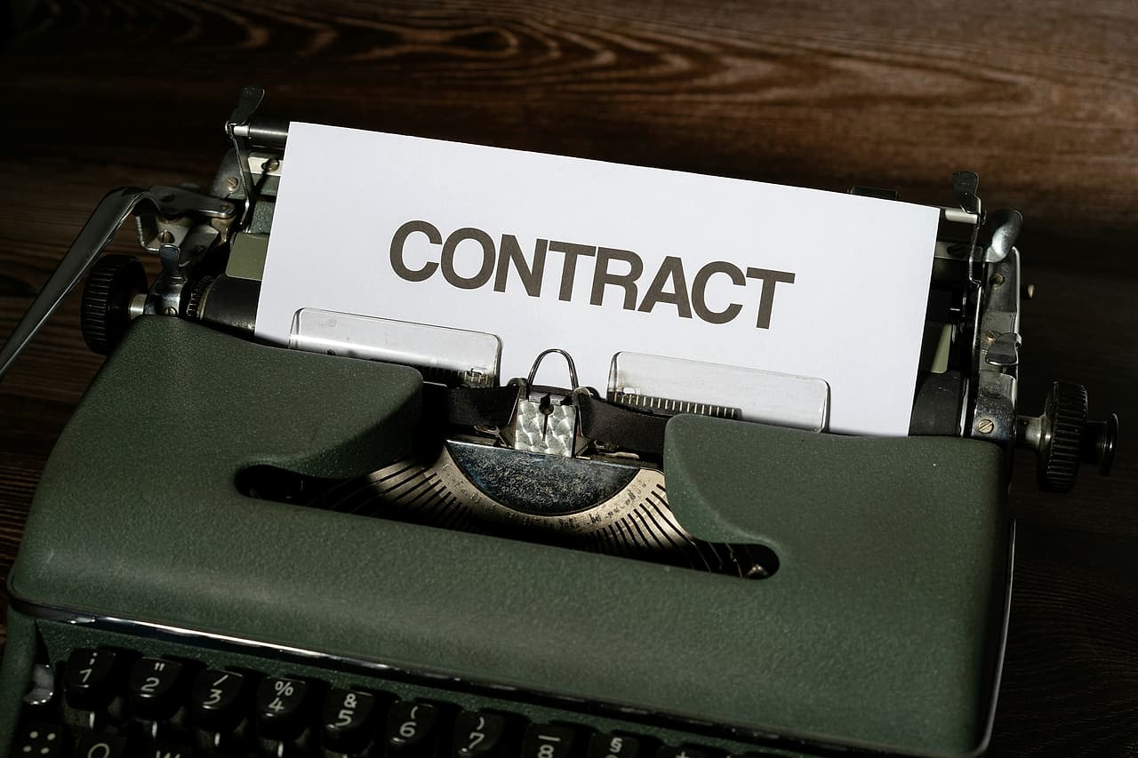 A page headed Contract sits in a typewriter.