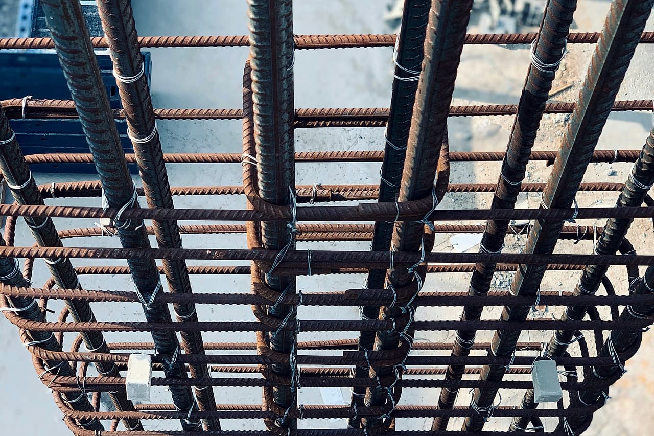 Looking down into a tied column reinforcing cage with plastic cover spacers fixed to the bars before the pour.